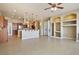 Open layout living room with kitchen, with built-in shelves and granite countertops at 3301 Rodeo Ave, Pahrump, NV 89048