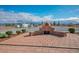 Outdoor patio area with a brick oven for cooking, surrounded by decorative shrubs at 3301 Rodeo Ave, Pahrump, NV 89048