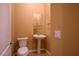 This cozy powder room features a pedestal sink, tile flooring, and neutral paint at 3301 Rodeo Ave, Pahrump, NV 89048