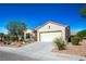 Tan house with a two-car garage and nicely landscaped front yard at 3320 Kookaburra Way, North Las Vegas, NV 89084