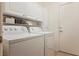 Laundry room with washer, dryer, and overhead cabinets at 3320 Kookaburra Way, North Las Vegas, NV 89084