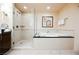 A bright bathroom featuring a walk-in shower and a luxurious tub at 135 E Harmon Ave # 3704, Las Vegas, NV 89109