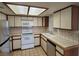 Bright kitchen with white appliances and wood cabinets at 1321 Del Mar St # 4, Las Vegas, NV 89119