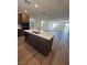 Kitchen island with white countertop and dark gray cabinets at 1448 Nocturnal Flight St, Las Vegas, NV 89138