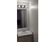 Bathroom vanity with sink, mirror, and lighting at 5049 Spencer St # D, Las Vegas, NV 89119