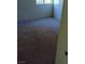 Carpeted bedroom includes a window and a light switch on the wall at 5049 Spencer St # D, Las Vegas, NV 89119