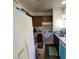 Functional kitchen features wood cabinets, a white range, and a stainless steel sink at 5049 Spencer St # D, Las Vegas, NV 89119
