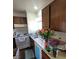 A basic kitchen with wood cabinets, a white range, and a stainless steel sink at 5049 Spencer St # D, Las Vegas, NV 89119
