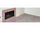 View of the carpeted living room featuring a fireplace with brick-look tile surround at 5049 Spencer St # D, Las Vegas, NV 89119