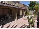 Covered patio, gravel yard, cactus, and small table with chairs at 1708 Walrus St, Las Vegas, NV 89117