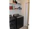 Laundry room with washer, dryer, and storage shelves at 1708 Walrus St, Las Vegas, NV 89117