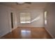 Bright living room with hardwood floors and two windows at 1708 Walrus St, Las Vegas, NV 89117