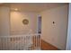 Upstairs hall with white railing and hardwood floors at 1708 Walrus St, Las Vegas, NV 89117