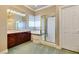 Primary bathroom with soaking tub, shower, and dark wood cabinets at 1860 E Ford Ave, Las Vegas, NV 89123