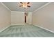 Spacious bedroom with light carpet and ceiling fan at 1860 E Ford Ave, Las Vegas, NV 89123