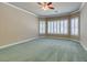 Large bedroom with plush carpet, ceiling fan, and window shutters at 1860 E Ford Ave, Las Vegas, NV 89123