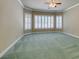 Large bedroom with plush carpet, ceiling fan and window shutters at 1860 E Ford Ave, Las Vegas, NV 89123