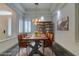 Elegant dining room with a rustic wooden table and leather chairs at 1860 E Ford Ave, Las Vegas, NV 89123