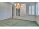 Spacious dining room with a chandelier and large windows with plantation shutters at 1860 E Ford Ave, Las Vegas, NV 89123