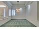 Formal dining room featuring a crystal chandelier and soft green carpeting at 1860 E Ford Ave, Las Vegas, NV 89123