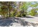 Gravel driveway with mature trees and landscaping at 1860 E Ford Ave, Las Vegas, NV 89123