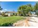 House exterior showcasing a large yard and driveway at 1860 E Ford Ave, Las Vegas, NV 89123