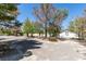 Large front yard with gravel and mature trees at 1860 E Ford Ave, Las Vegas, NV 89123