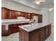 Kitchen boasts granite island, stainless steel appliances, and ample cabinetry at 1860 E Ford Ave, Las Vegas, NV 89123