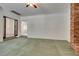 Living room featuring a brick fireplace and green carpeting at 1860 E Ford Ave, Las Vegas, NV 89123