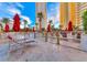 Resort pool with red umbrellas and lounge chairs at 145 E Harmon Ave # 1121, Las Vegas, NV 89109