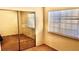 Bedroom featuring mirrored closet and window with blinds at 5860 Medallion Dr # 202, Las Vegas, NV 89122