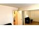 Cozy bedroom with mirrored closet doors and access to another room at 5860 Medallion Dr # 202, Las Vegas, NV 89122