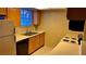 Kitchen with light wood cabinets, stainless steel sink, and appliances at 5860 Medallion Dr # 202, Las Vegas, NV 89122