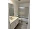 Clean, standard bathroom features a tub/shower combination with sliding glass doors at 3422 Pino Cir, Las Vegas, NV 89121