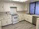 Efficient kitchen featuring white appliances and laminate flooring at 3422 Pino Cir, Las Vegas, NV 89121