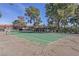 Community tennis court with green surface and surrounding trees at 3422 Pino Cir, Las Vegas, NV 89121