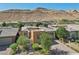 Aerial view showcasing the home's unique design and surrounding landscape at 10057 Regency Canyon Way, Las Vegas, NV 89148