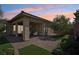 Covered patio with seating area and lush landscaping at 10057 Regency Canyon Way, Las Vegas, NV 89148