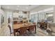 Bright dining area with a large wooden table and seating for six at 10057 Regency Canyon Way, Las Vegas, NV 89148