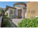 Charming front patio with seating area and beautiful landscaping at 10057 Regency Canyon Way, Las Vegas, NV 89148