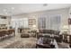 Living room with hardwood floors, comfortable seating and large windows at 10057 Regency Canyon Way, Las Vegas, NV 89148