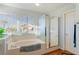 Bright bathroom with a tub, glass shower and large window for natural light at 1002 Prestige Meadows Pl, Henderson, NV 89052