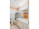 Well-lit bathroom with double sinks, white cabinets, and decorative mirror at 1002 Prestige Meadows Pl, Henderson, NV 89052
