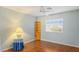 Cozy bedroom with wood flooring and window, plus a wooden shelf and vintage side table at 1002 Prestige Meadows Pl, Henderson, NV 89052