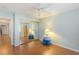 Bright bedroom with wood floors, closet with mirrored doors, and modern ceiling fan at 1002 Prestige Meadows Pl, Henderson, NV 89052