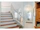 Bright entryway with a soaring ceiling, decorative lighting, and an elegant staircase with white railing at 1002 Prestige Meadows Pl, Henderson, NV 89052