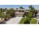 Beautiful two-story home boasts a three-car garage, mature trees, and a well-manicured lawn at 1002 Prestige Meadows Pl, Henderson, NV 89052
