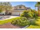 Charming two-story home featuring a three-car garage and beautifully landscaped front yard at 1002 Prestige Meadows Pl, Henderson, NV 89052