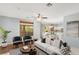 Stylishly staged living room with modern furnishings, natural light, and an open layout flowing into the kitchen at 1002 Prestige Meadows Pl, Henderson, NV 89052