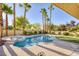 Inviting backyard pool and spa surrounded by lush landscaping and tall palm trees for a private oasis at 1002 Prestige Meadows Pl, Henderson, NV 89052